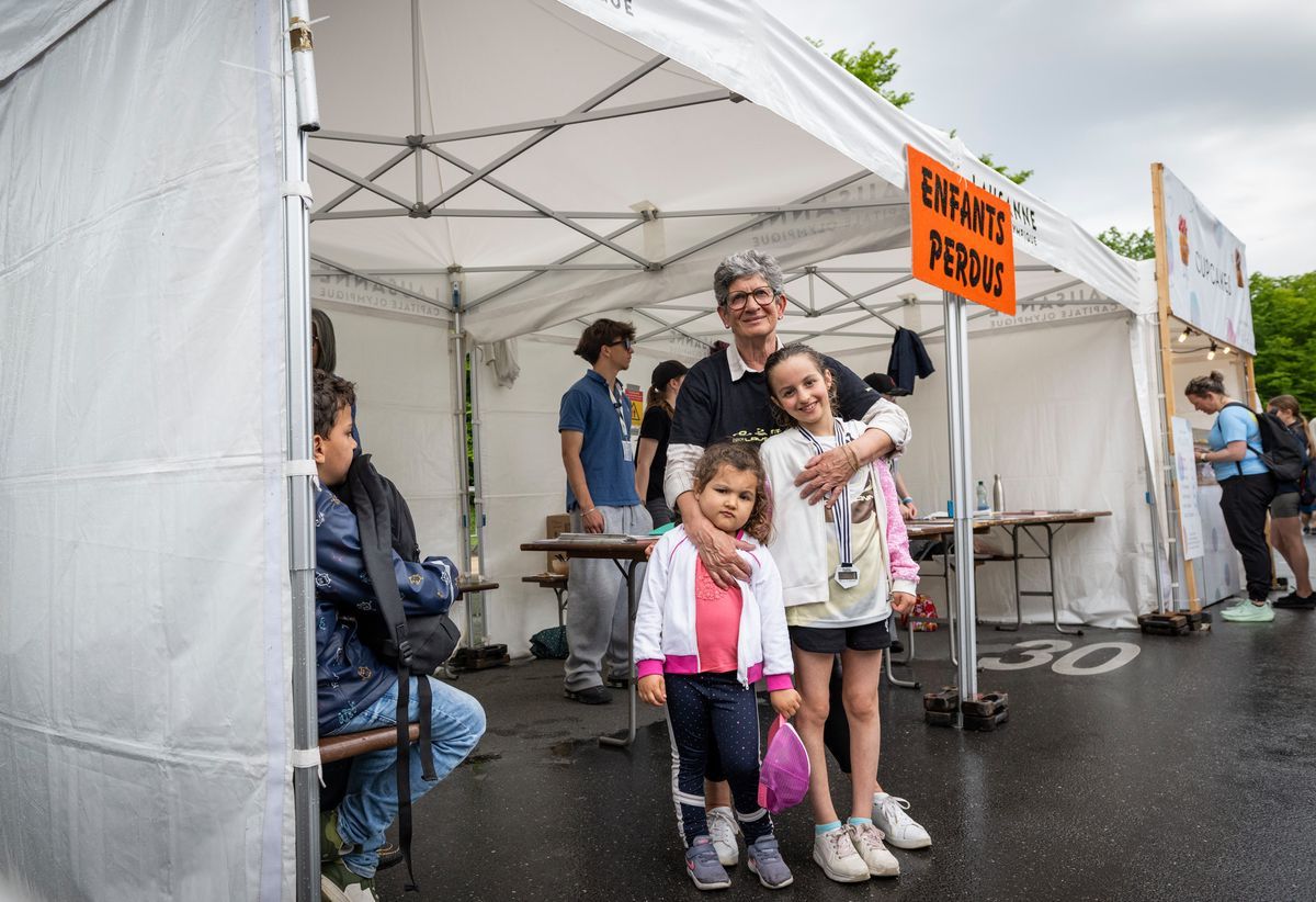 Un stand d'enfants a perdu 20 km de Lausanne, avec un bénévole et deux enfants souriants devant la tente. Photo Jean-Guy Python. Un stand d'enfants a perdu 20 km de Lausanne, avec un bénévole et deux enfants souriants devant la tente. Photo Jean-Guy Python.